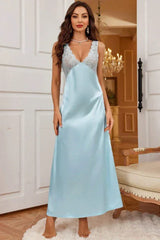 Woman wearing a light blue satin slip dress with lace trim, standing in a doorway