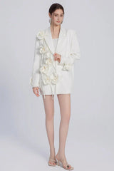 Model showcasing a white blazer dress with intricate floral details