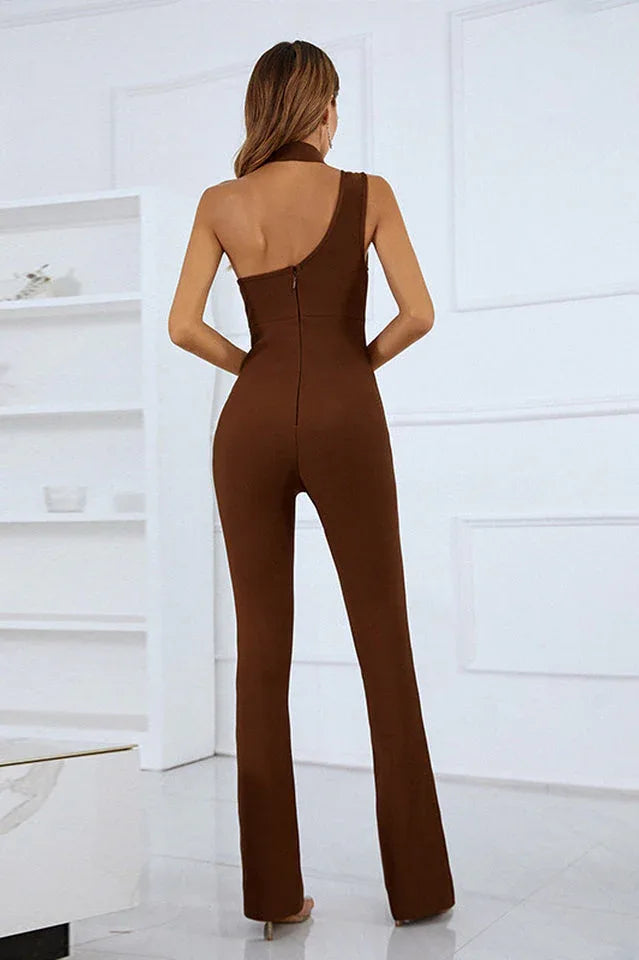 Back view of a woman in a brown one-shoulder jumpsuit with a zip closure and flared legs.