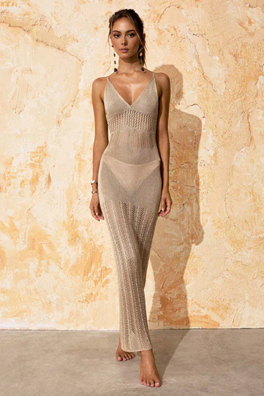 Woman wearing a beige knit maxi dress with spaghetti straps and a V-neckline, standing against a textured wall.