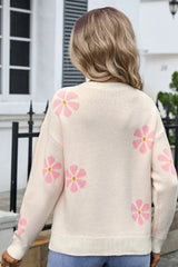 Back view of a woman wearing a cream-colored knit sweater with a pink floral print.