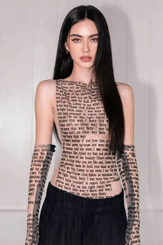 Woman wearing a sleeveless black top with text print.