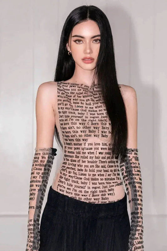 Woman wearing a sleeveless black top with text print.