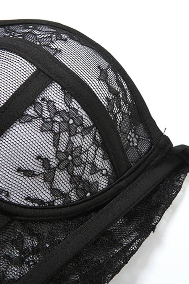 Close-up of the black lace and mesh fabric of a corset top