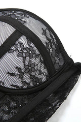 Close-up of the black lace and mesh fabric of a corset top