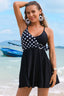 Woman wearing a black and white polka dot swimdress on a beach
