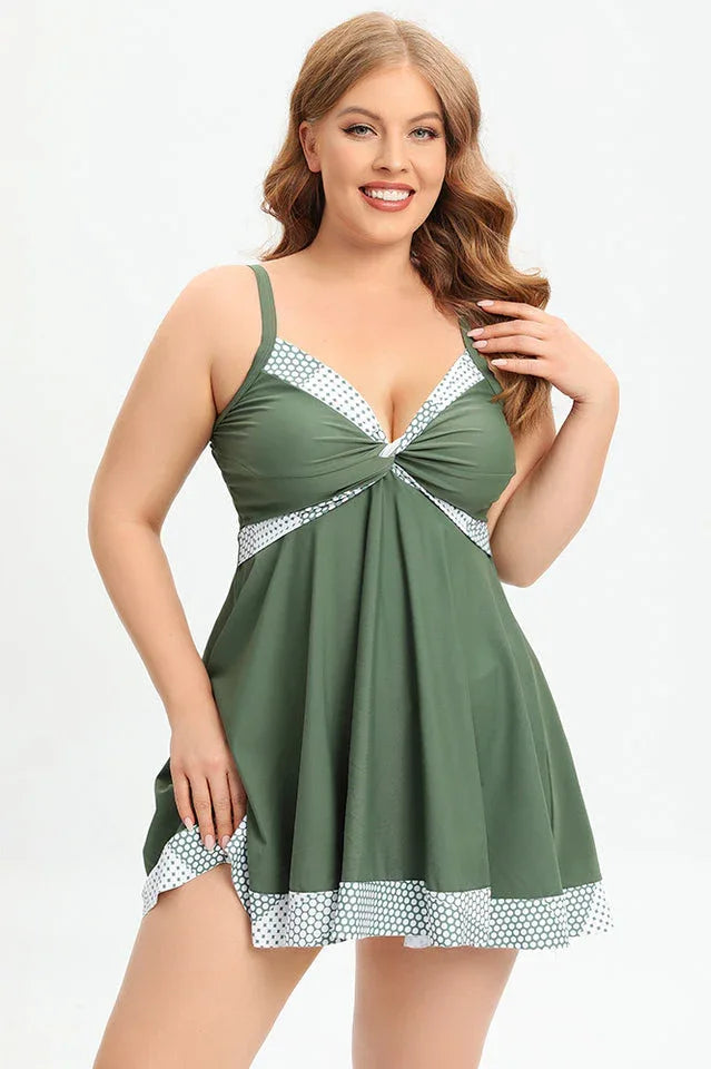 Plus-size olive green swim dress with polka dot trim and twisted front