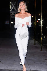 woman in a white off-the-shoulder ruched maxi dress and white handbag
