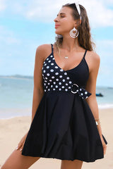 Woman wearing a black and white striped swimdress on a beach