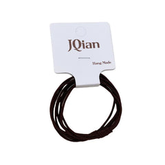 Close-up of a single brown elastic hair tie on branded cardstock.