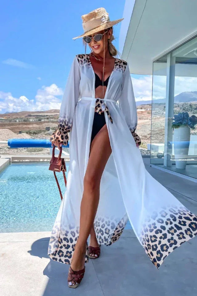 Woman wearing a white leopard print trim maxi duster over a black bikini