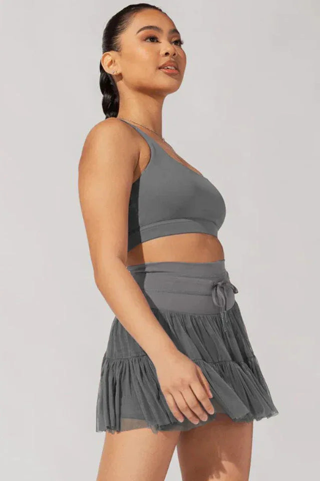 Side view of woman in grey activewear set
