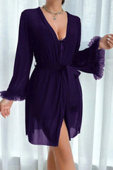Woman wearing a purple sheer robe with ruffled cuffs and a tie waist, showcasing the matching chemise underneath