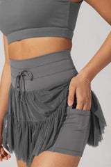Close-up of pocket detail on ruffled tulle skirt