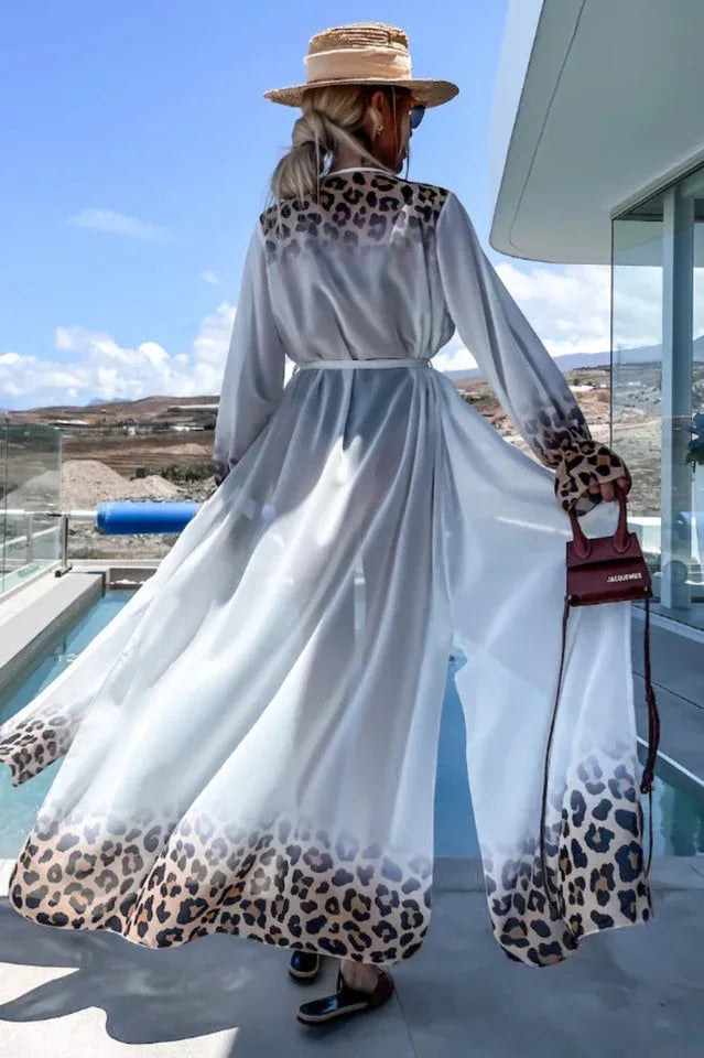 Back view of a woman wearing a white leopard print trim maxi duster