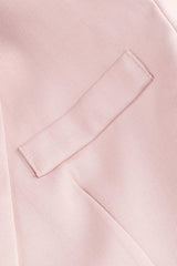 Close-up of the flap pocket detail on the pink blazer