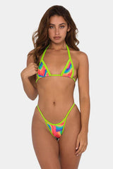 Woman wearing a rainbow print bikini with neon green trim.