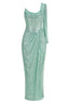 Front view of a mint green sequined column gown with a high slit and draped detail.