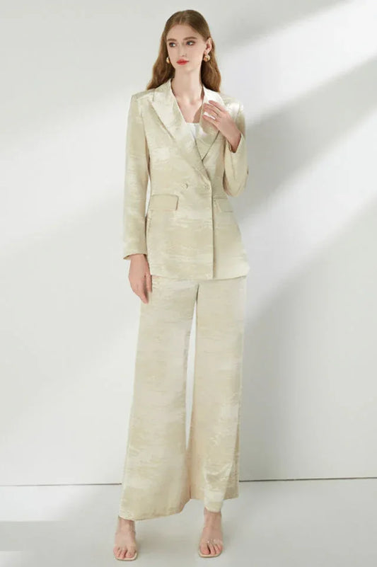 Woman wearing a cream jacquard double-breasted blazer and matching wide-leg pants.