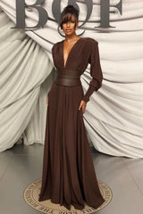Full-length shot of a model wearing a brown V-neck maxi dress with long sleeves.