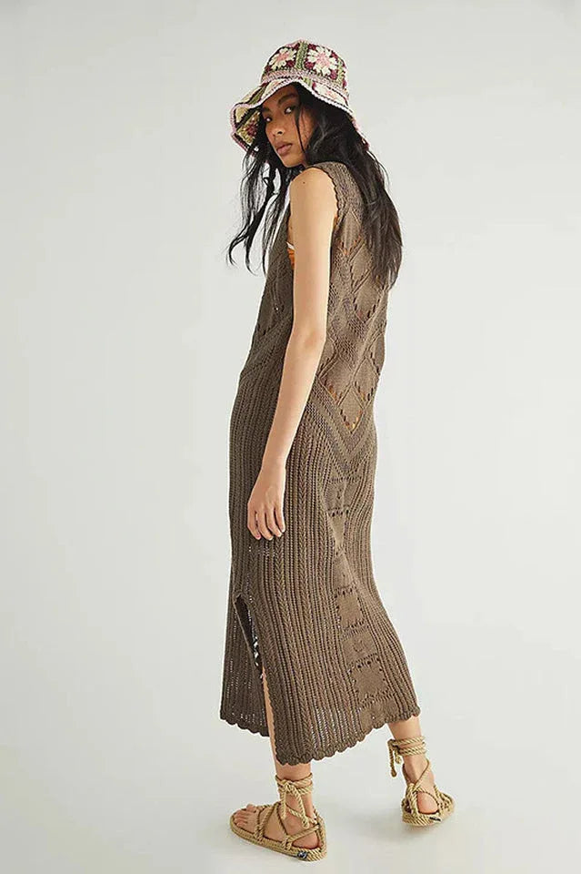side view of a woman wearing a brown crochet knit midi dress, a tie-dye scarf, a bucket hat, and sandals