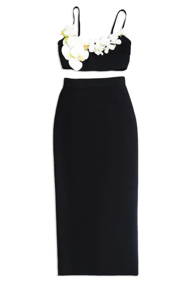 Black crop top with floral embellishments and a matching midi skirt, displayed separately.