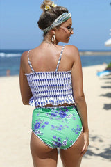 Woman sitting on a beach chair in a floral print bikini