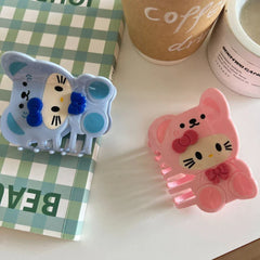Close-up of blue and pink character hair claw clips on a table