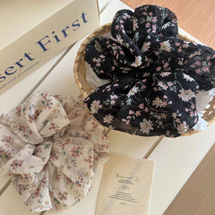 Two floral print chiffon scrunchies in a basket