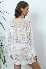 Back view of a woman wearing a white crochet knit tunic.