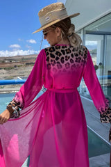 Back view of a woman wearing a pink leopard print trim maxi duster