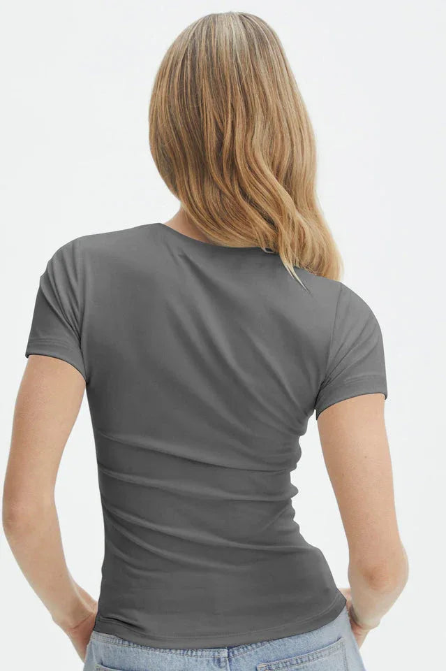 Back view of a woman wearing a grey short-sleeve t-shirt