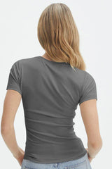 Back view of a woman wearing a grey short-sleeve t-shirt