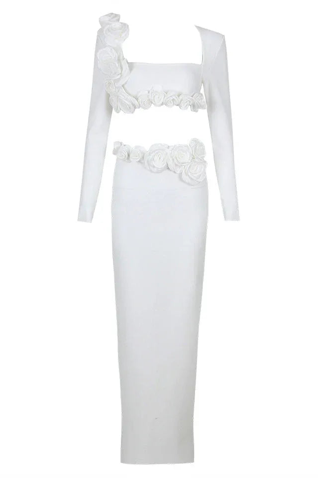 Studio shot of a white formal gown with a square neckline and long sleeves.