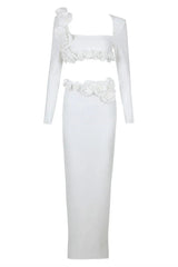 Studio shot of a white formal gown with a square neckline and long sleeves.