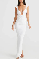 Woman wearing a long white sleeveless dress with a plunging V-neck and a cutout detail at the bust.