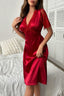 Woman wearing a red satin nightgown with lace details