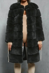Woman wearing a dark gray faux fur coat over a beige bodysuit and thigh-high socks.