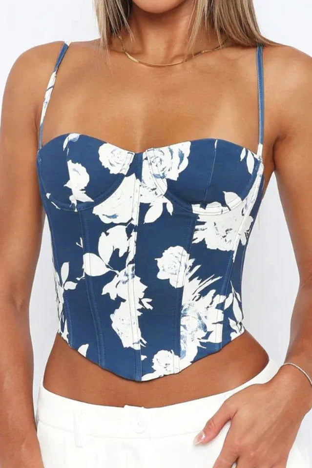 Close-up front view of a blue floral print corset top with sweetheart neckline and thin straps.