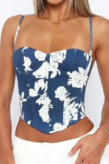 Close-up front view of a blue floral print corset top with sweetheart neckline and thin straps.