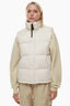 Woman wearing a cream puffer vest over a cream sweatshirt and tan cargo pants