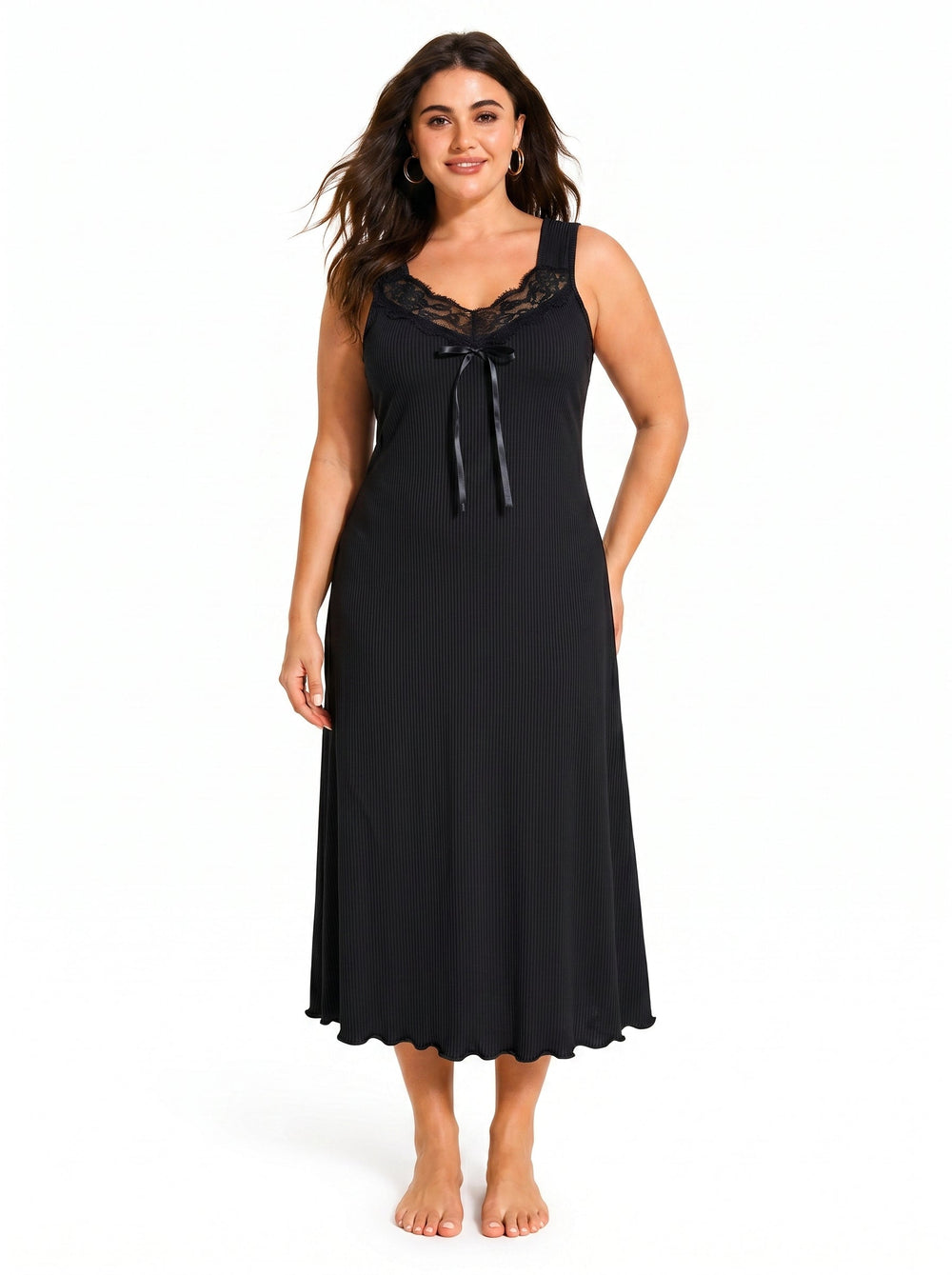Woman wearing a black ribbed knit nightgown with lace trim and a bow
