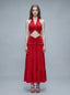 Woman wearing a red halter crop top and a tiered maxi skirt, front view
