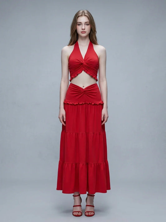 Woman wearing a red halter crop top and a tiered maxi skirt, front view