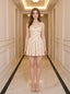Woman wearing a yellow floral print mini dress with spaghetti straps and a sweetheart neckline standing in a hallway.