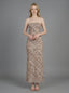 Woman wearing a strapless, patterned maxi dress standing against a grey background, front view.