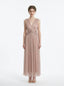 Woman in a rose gold shimmering metallic A-line V-neck sleeveless floor-length formal gown, front view