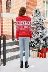 Back view of a woman wearing a red Christmas sweater with snowflake patterns