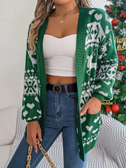Woman wearing a green and white Fair Isle knit cardigan with an open front, pockets, and holding a gold chain purse.