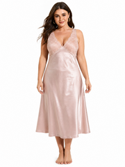Woman wearing a pink satin midi slip dress with lace detail on the bust and back